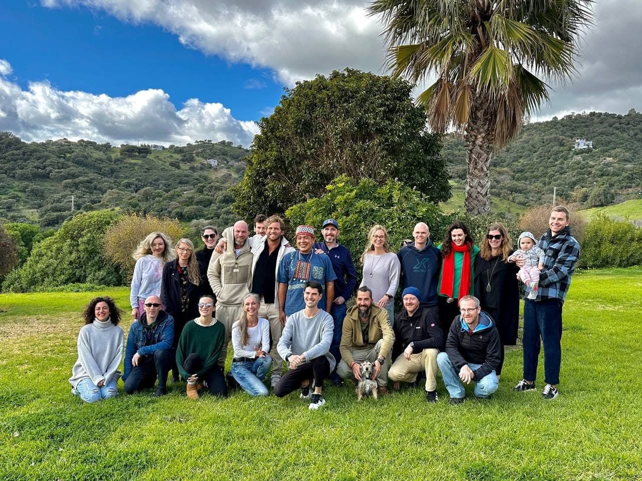 A retreat group of about twenty people with a Shipibo maestro, on a lawn in the Spanish hills.