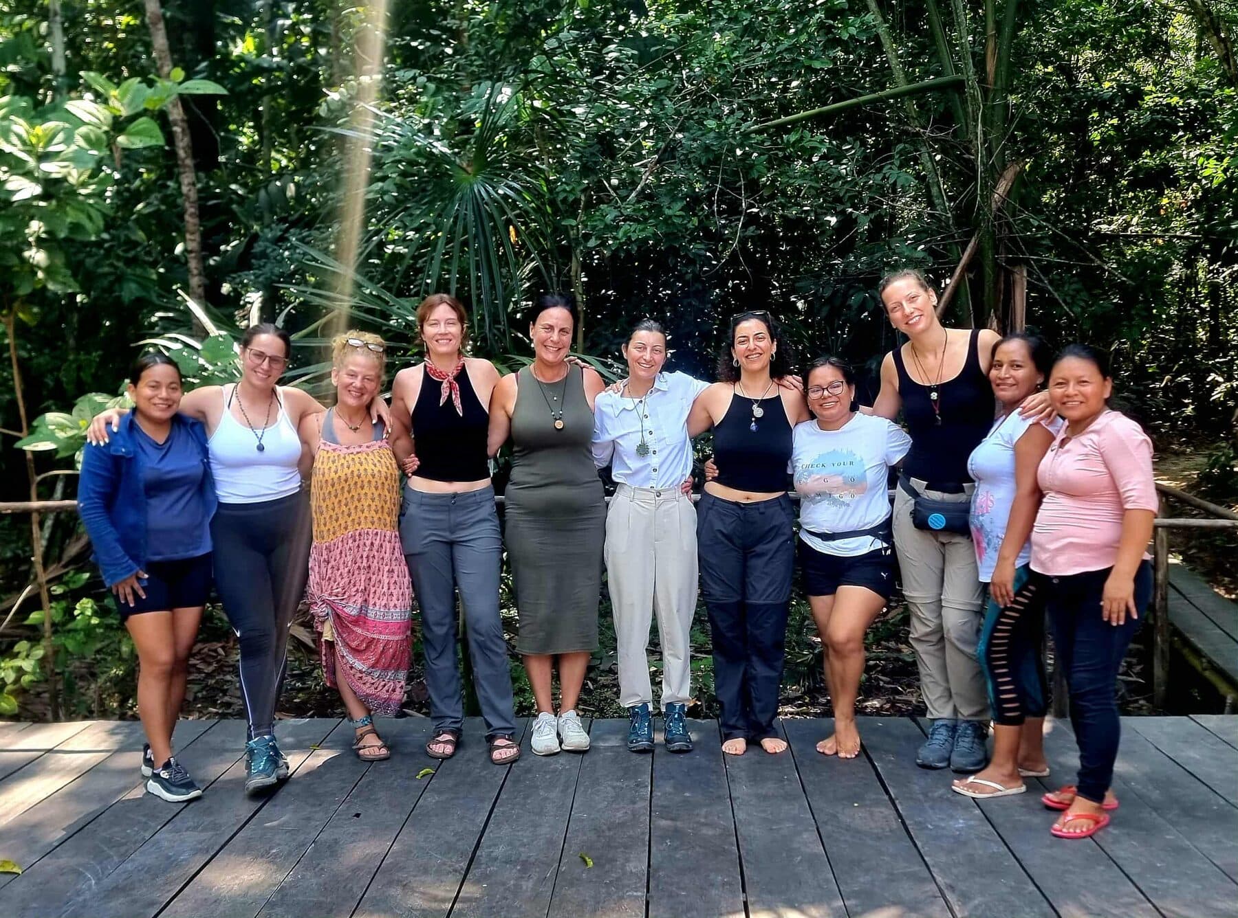 Women from a retreat group gathered on a wooden deck in the Peruvian jungle.